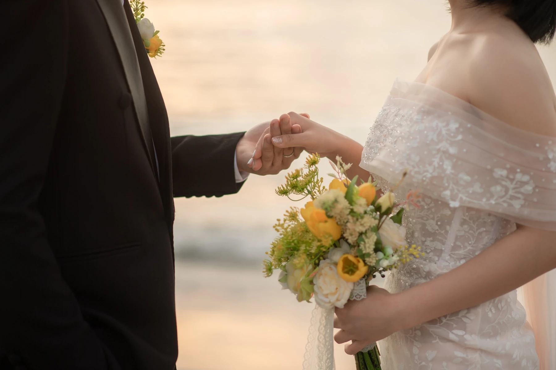 Wedding couple holding hands