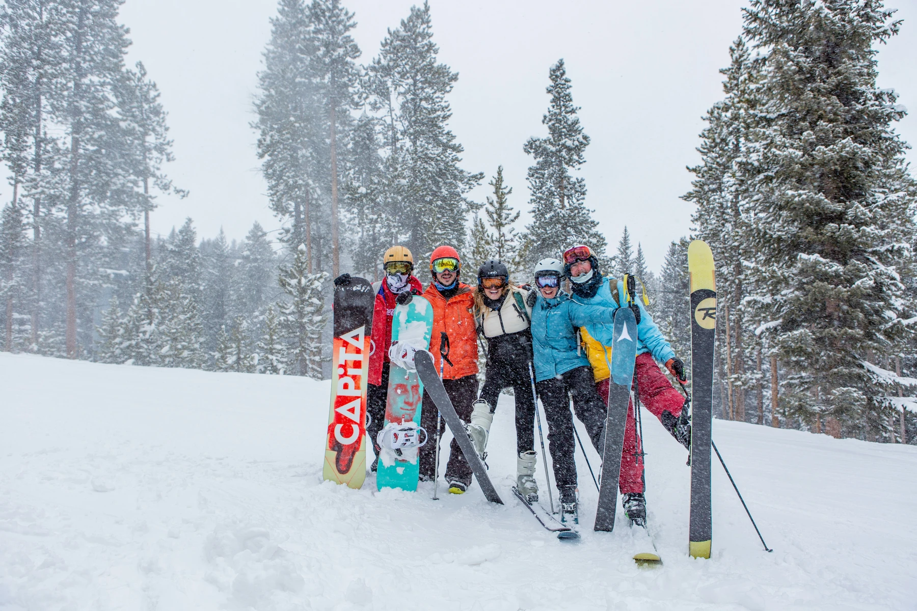 Group together with skis and snowboards in the snow